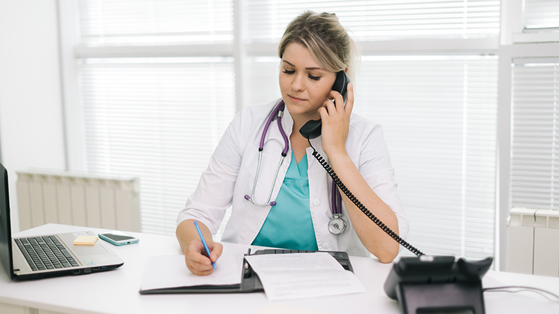 Portrait Of Young Woman Doctor In White Uniform Sitting At The Table|Health Studies Health Studies