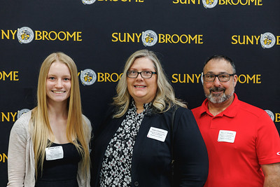 Kendal Valenti poses for a photo with donors, Edith Lianexay and Shane Woollett