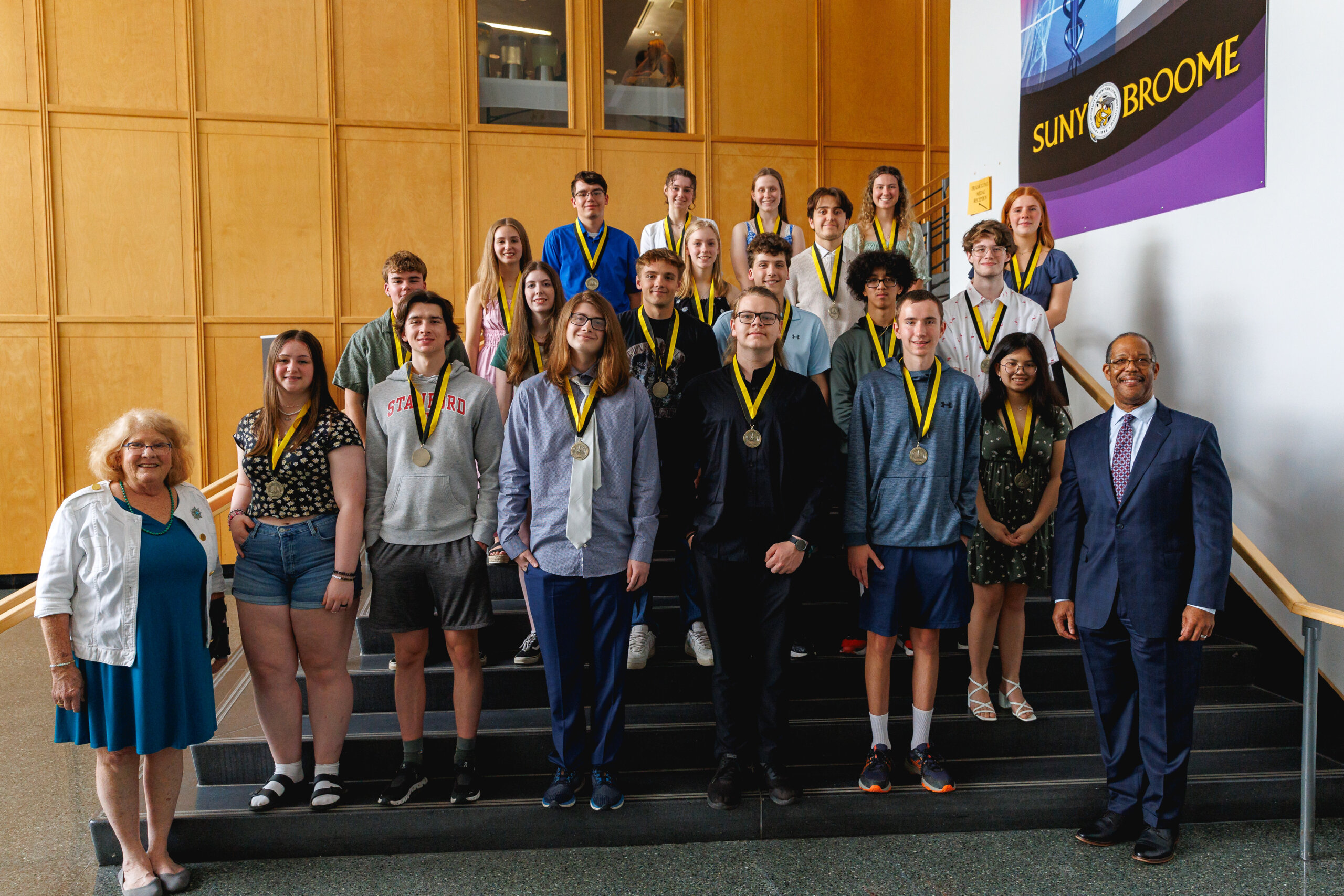 Frank G. Paul recipients wear their medals as they stand with Dr. Hawkins and Rebecca Komorowski