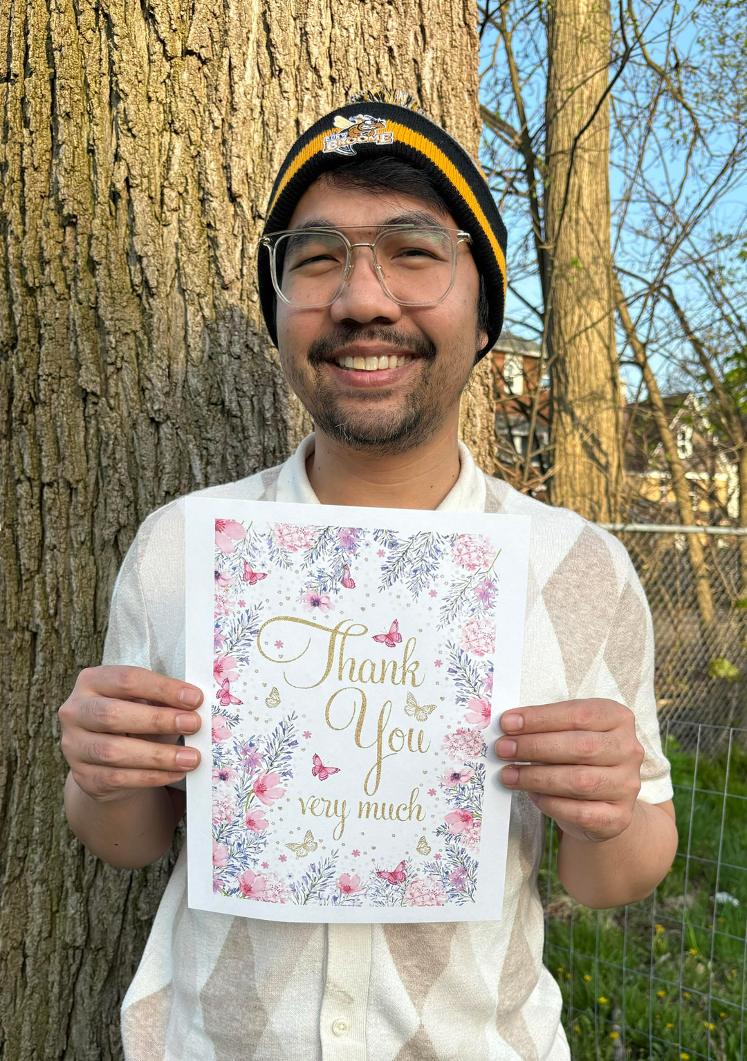 Channarong Campbell holds up a thank you sign