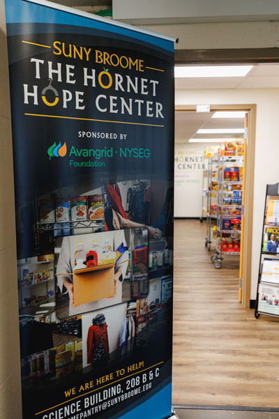 A banner that reads Hornet Hope Center and some shelves of canned goods.