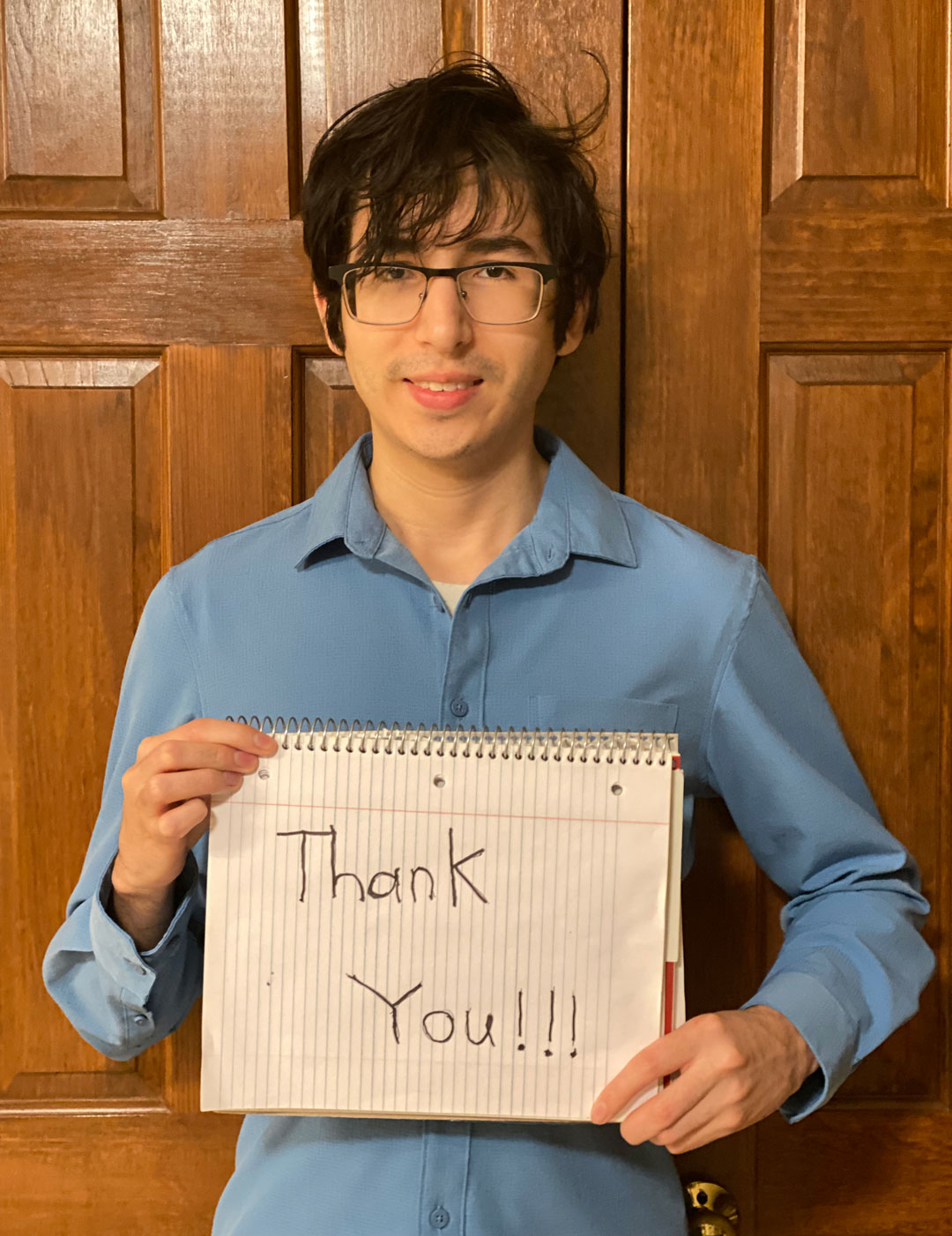 Matt Larson holds up a thank you sign.