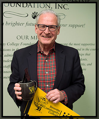 Michael Sullivan smiles as he holds his VIP gifts