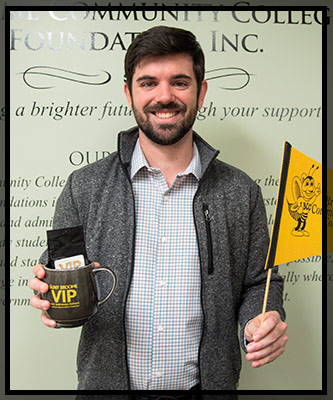 Kevin Bryant holds up his VIP items