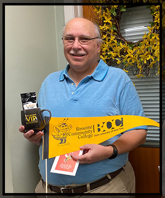 Rick Kazmark holds up his VIP items
