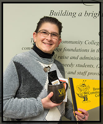 Christina smiles and holds her VIP gifts