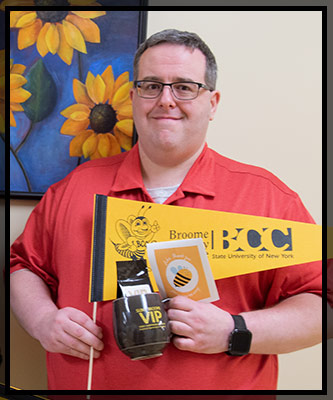 John smiles as his photo is taken