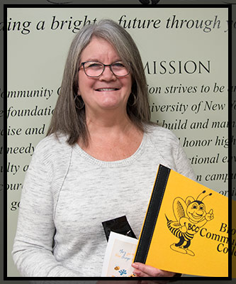 Mary smiles and holds her VIP gifts