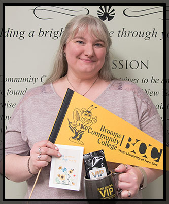 Heidi smiles as she holds her VIP items
