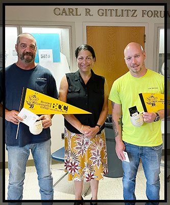 Justin and Robert hold their VIP gifts in the Titchener lobby.