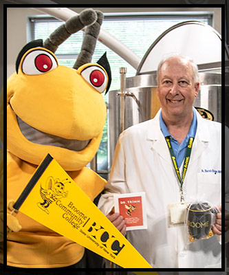 Dr. Harold Trimm holds up his gift