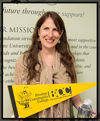 Laura smiles as she holds her gift of coffee