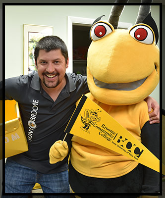 Ryan hugs Stinger and his mail-bin.