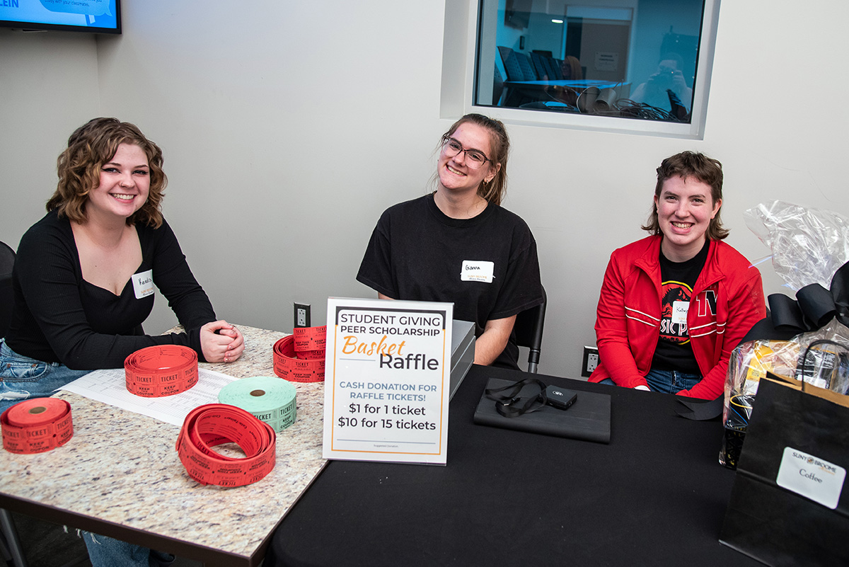 Volunteers running the Basket Raffle table at Alumni Reunion 2024