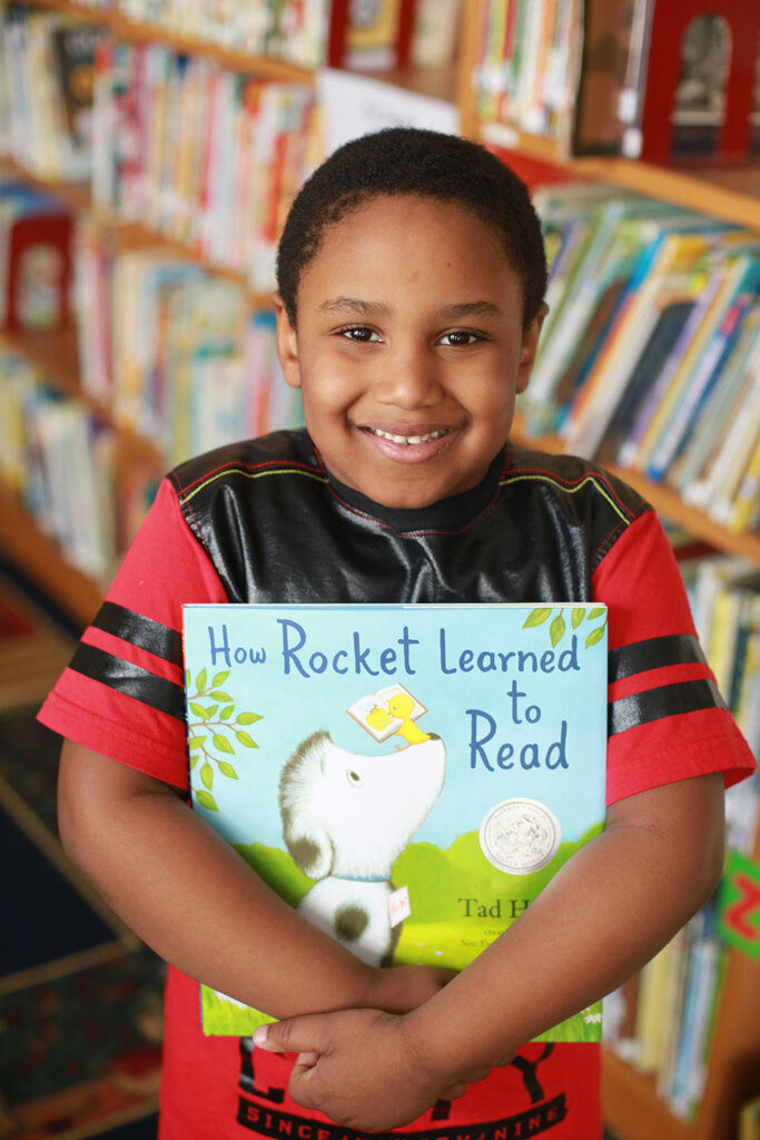 Young boy holding a book
