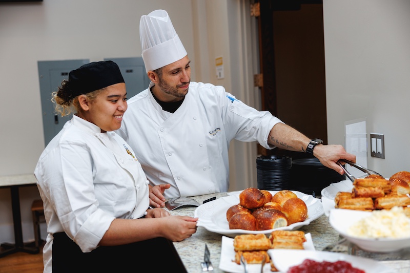 hospitality students cooking at culinary and event center