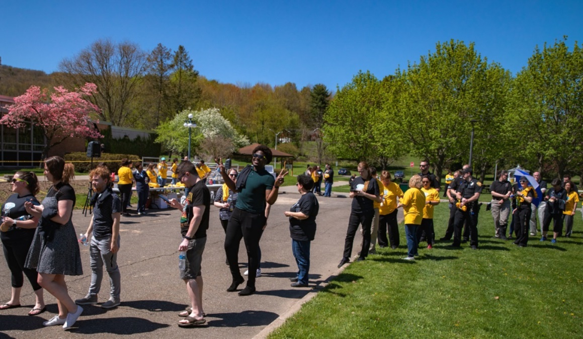 outside on campus with lot of students