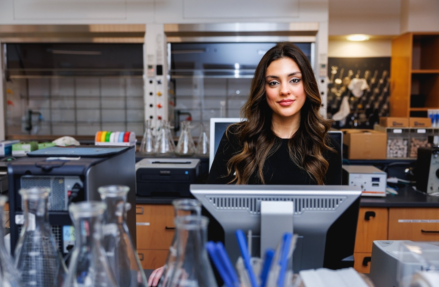 suny broome student Teacher helping a student with his classwork in a library.