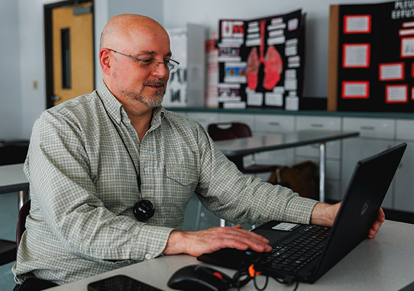Michael Buffone sitting in a SUNY Broome nursing classroom